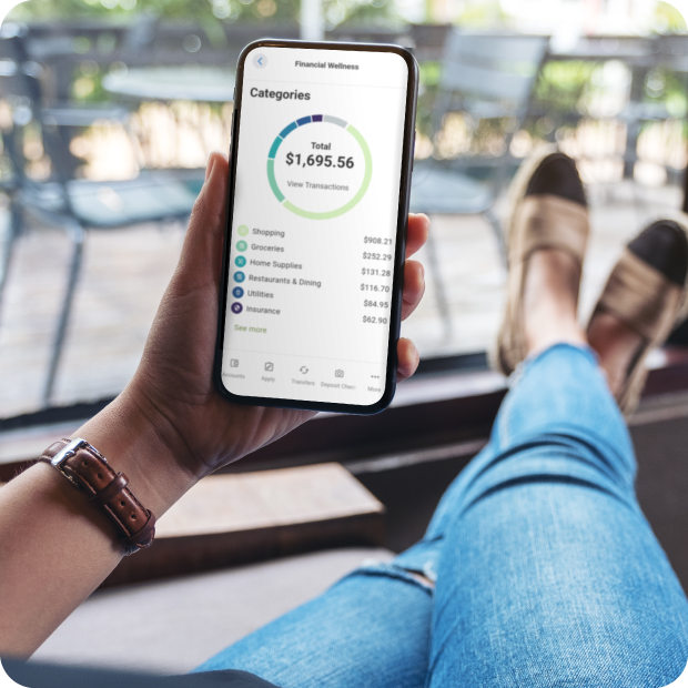 Guardian CU member relaxes on porch using mobile app for financial wellness.