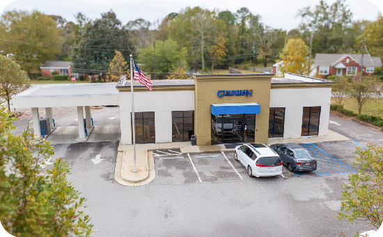 Exterior view of Guardian Credit Union’s Tallassee branch building, with visible parking lot.