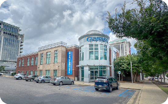 Exterior view of Guardian CU’s 418 Madison Ave branch building, with visible parking lot.