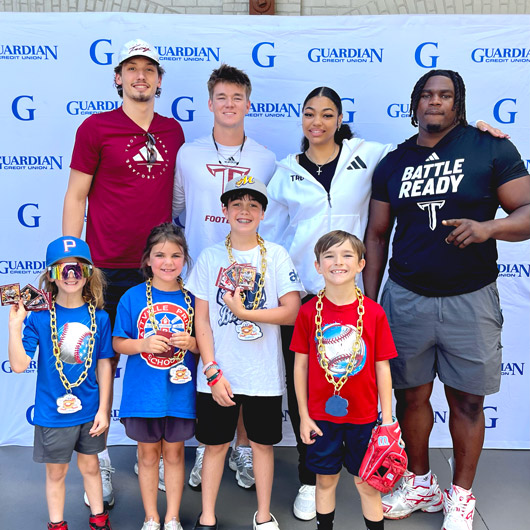 2nd Annual Guardian Day at the Biscuits with Troy athletes engaging enthusiastic young fans.