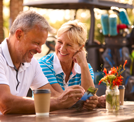 Smiling retired couple relieved to be free from financial worries.