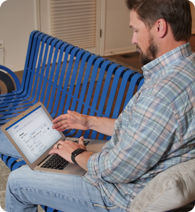 Man managing finances through Guardian Credit Union's secure online banking platform on his laptop