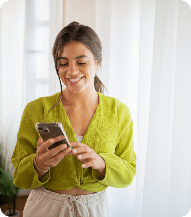 Smiling woman using smartphone to manage finances with Guardian Credit Union mobile banking app