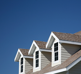 Roofline of a modern home under clear blue sky, representing Guardian Credit Union’s conventional mortgage loan options