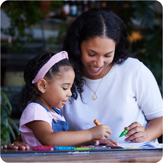 Parent teaches child about credit, reflecting Guardian CU’s youth financial literacy focus.