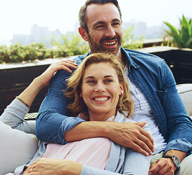 Happy couple relaxing outdoors, feeling confident about their future with Guardian Credit Union’s services.