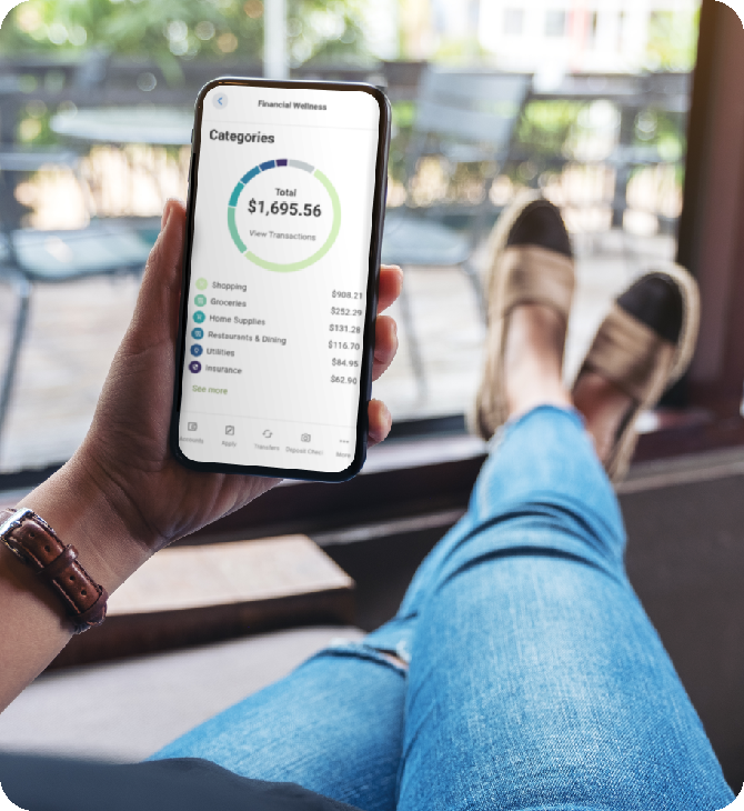 Guardian CU member relaxes on porch using the mobile app for financial wellness.