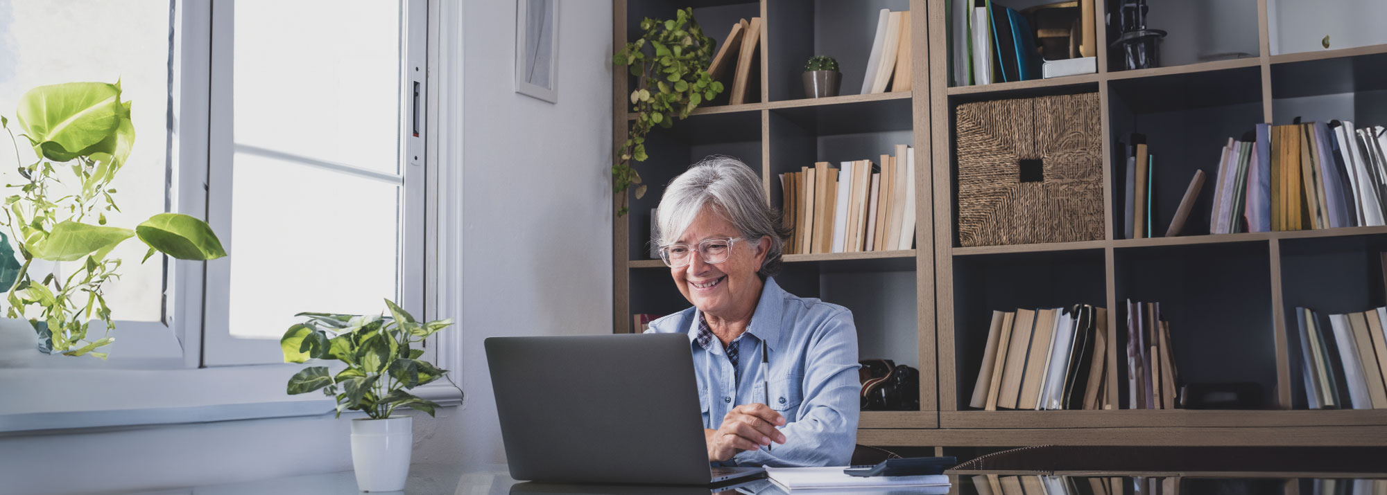 Guardian Credit Union member smiling while checking that her financial information is safe and secure online.