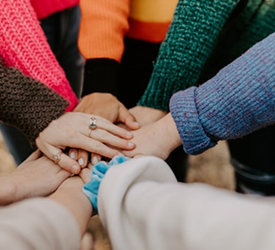 Community members joining hands in support, reflecting Guardian Credit Union’s local commitment