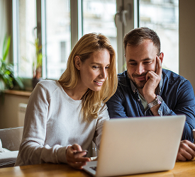 Couple reviewing finances on laptop, representing Guardian Credit Union’s financial education tools and online learning resources