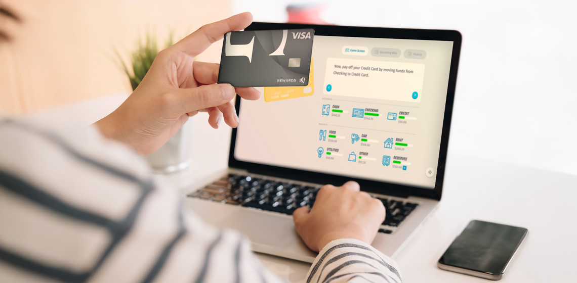 Person explores credit card and budget tools on laptop while learning about credit scores.