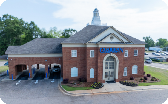 Exterior view of Guardian Credit Union’s Troy branch building, with visible parking lot.