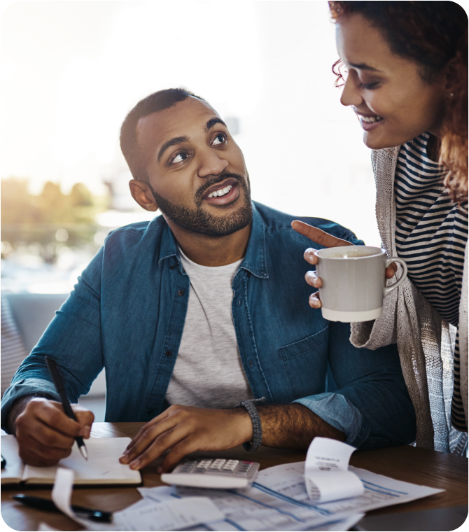 Happy couple celebrating after getting more for less, thanks to Guardian’s low interest rates.
