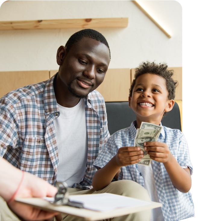 Father teaches son about money with cash, highlighting Guardian CU’s youth checking account.