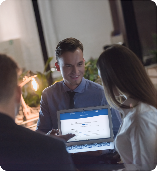Couple meeting with a Guardian Credit Union advisor to review lending rates options.