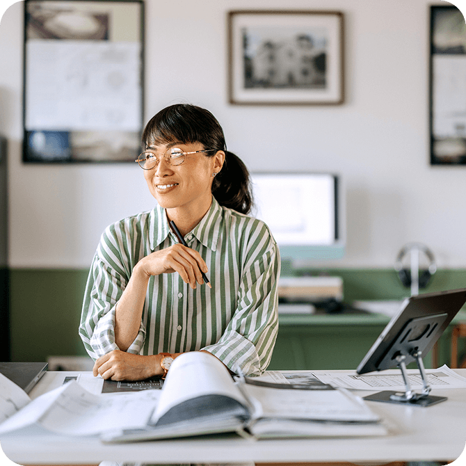 Businesswoman reviewing documents at desk, representing Guardian CU’s financial solutions and accounts for small businesses
