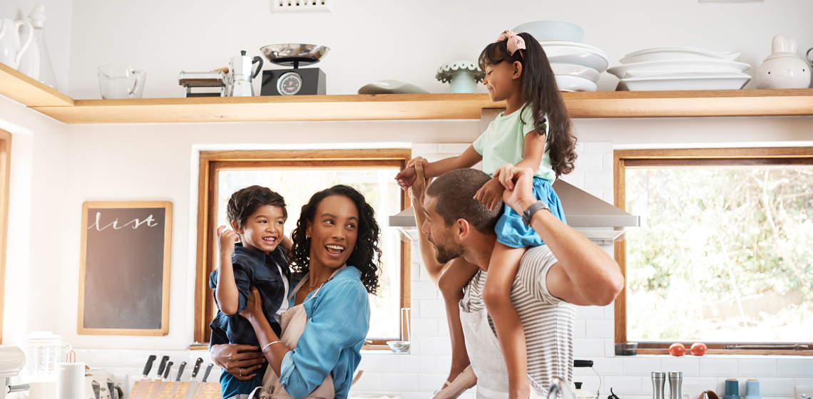 Family enjoying time together in a bright kitchen, symbolizing summer savings tips.