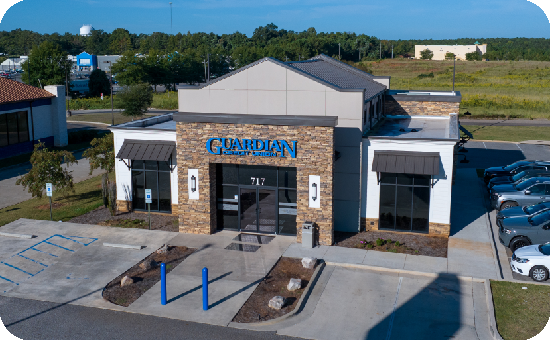 Exterior view of Guardian Guardian CU’s Greenville branch building, with visible parking lot.